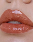 Close-up of glossy lips with a focus on texture and color.
