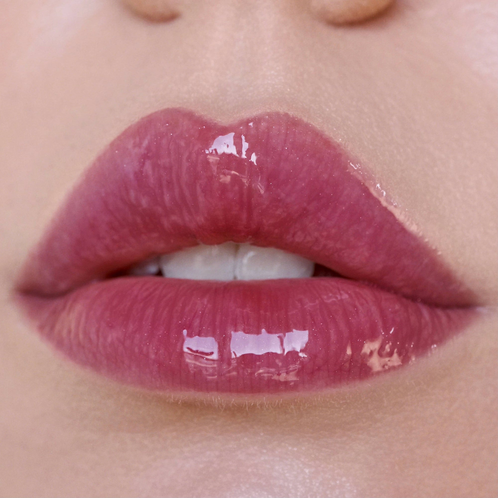 Close-up of glossy pink lips 